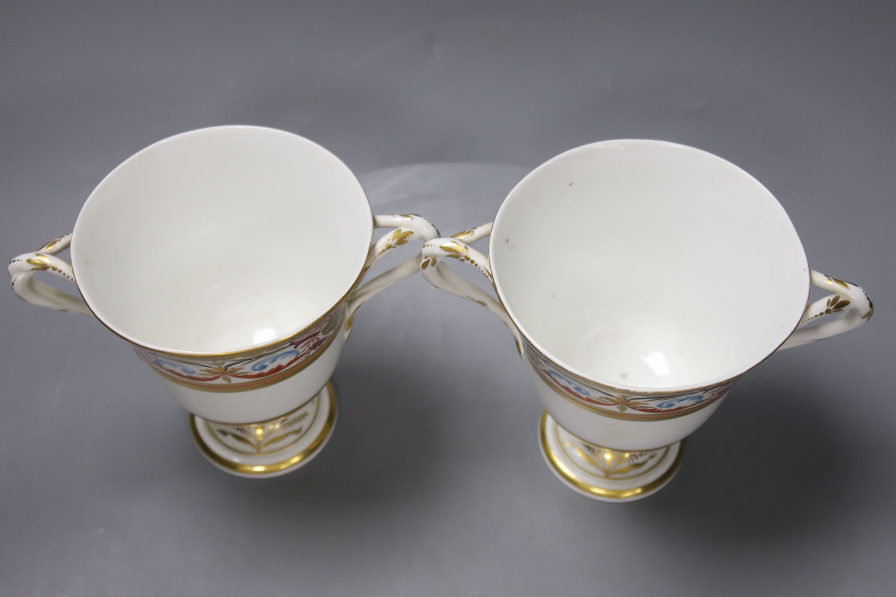 A pair of Derby two handled loving cups, c.1805, painted in arabesque style, pattern no.407, height 14cm